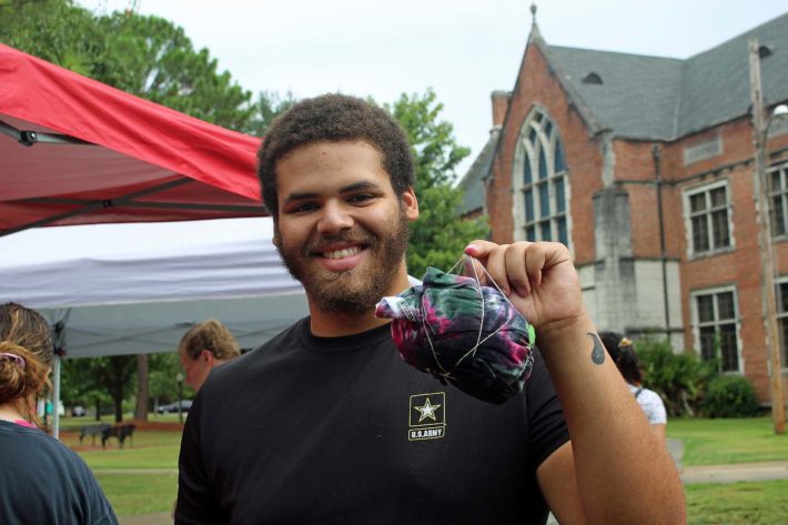 student holding tshirt